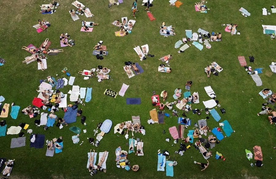 People sunbathe in Bern, Switzerland, on 19 June 2026.