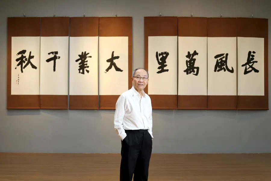 Lim See Young with the words that hung in the Nantah graduation tent, rewritten and exhibited in 2018. (SPH Media)