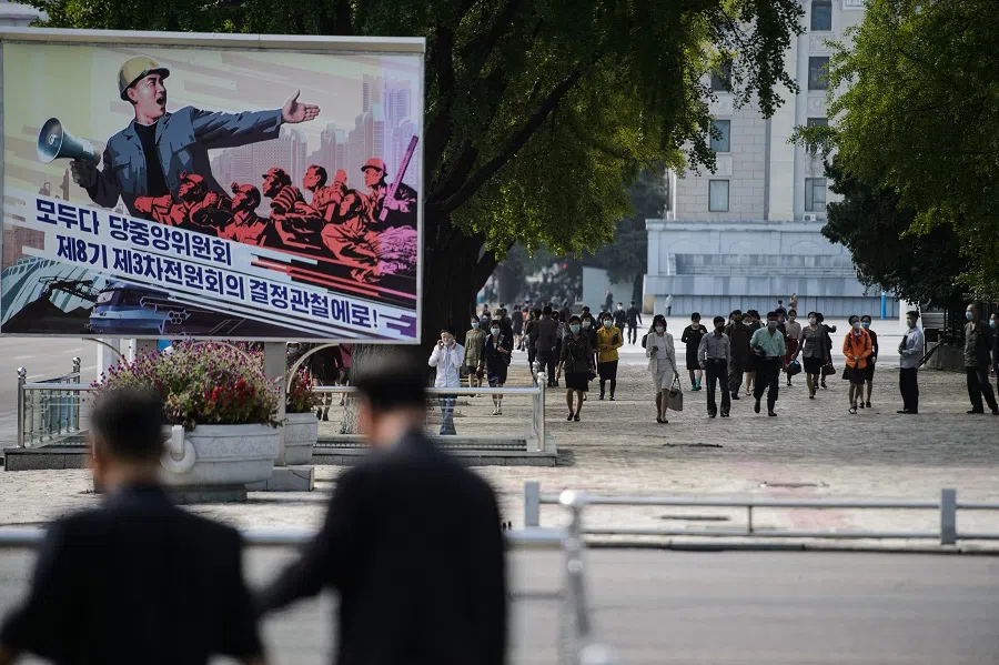  Pedestrians walk along Sungri Street, crossing the Kim Il Sung Square, in Pyongyang on 29 September 2021. (AFP)