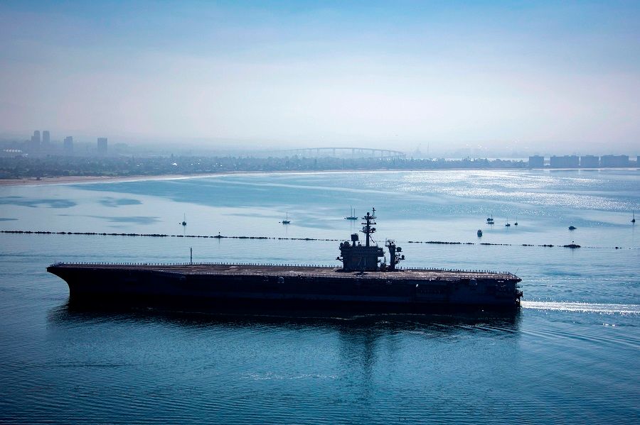 In this image released by the US Navy, the aircraft carrier USS Theodore Roosevelt returns to Naval Air Station North Island in San Diego, California, on 9 July 2020. (Jessica Paulauskas/US Navy/AFP)