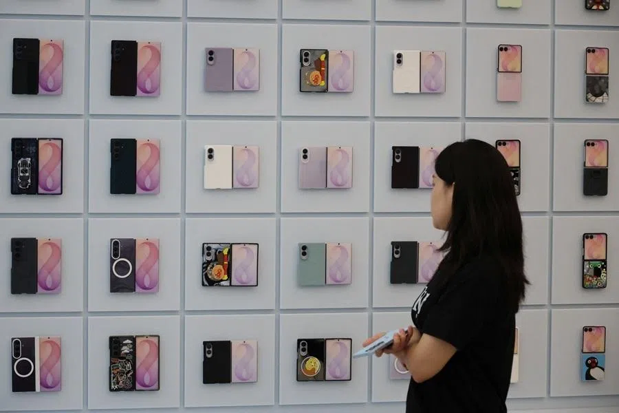 A woman takes a look at various mockups of Samsung Electronics' Galaxy foldable phones at its store in Seoul, South Korea, on 23 July 2026.