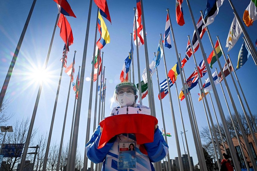 A staff prepares for the arrival of Thomas Bach, president of the International Olympic Committee before the Olympic Truce Mural ceremony at Beijing 2022 Winter Olympic Games village in Beijing, China, on 1 February 2022, ahead of the 2022 Beijing Winter Olympic Games. (Wang Zhao/Pool/AFP)
