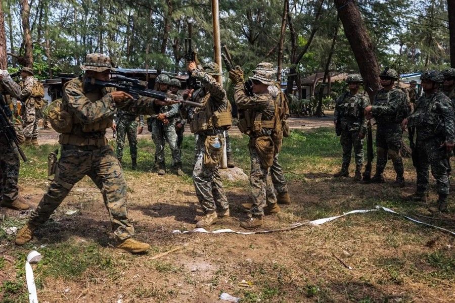 Members of the Philippine Marine Corps watch as the US Marines demonstrate close-quarters combat techniques during the 2023 Balikatan war games held at Naval Base Camilo Osias in Santa Ana town, Cagayan, Philippines on 11 April 2023. (Corporal Grace Gerlach/SPH Media)