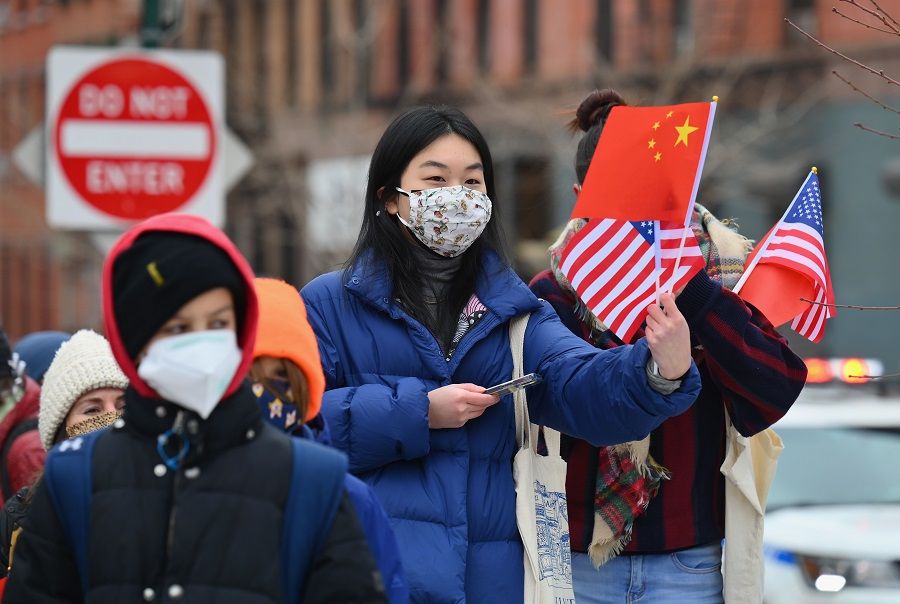 People celebrate the Lunar New Year holiday in Chinatown on 12 February 2021 in New York City, US. (Angela Weiss/AFP)