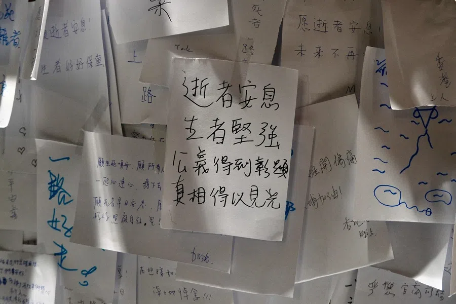 Messages left by mourners are seen during a vigil held outside the Wang Fuk Court apartment blocks in the aftermath of the deadly fire in Hong Kong's Tai Po district on 3 December 2025. (Tommy Wang/AFP)