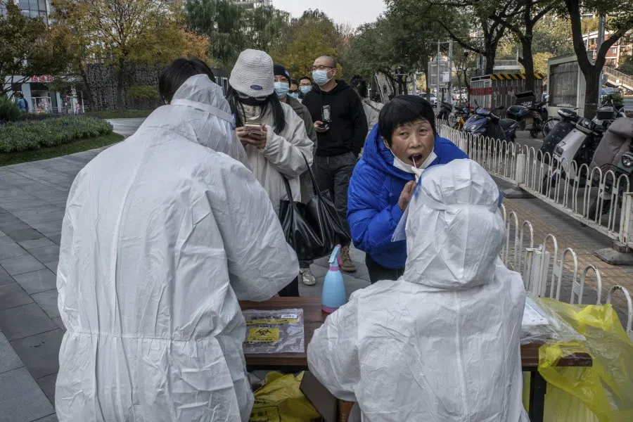 People wait in line to be tested for Covid-19 at a nucleic acid testing station in Beijing on 10 November 2022. (Jade Gao/AFP)