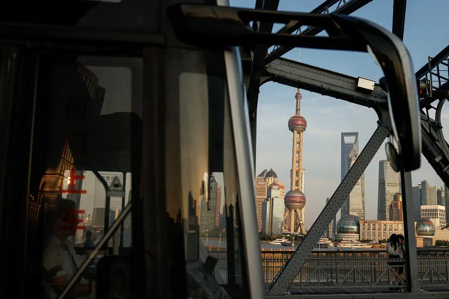 A bus moves past a bridge with the backdrop of the financial district of Pudong in Shanghai, China, on 27 September 2024.