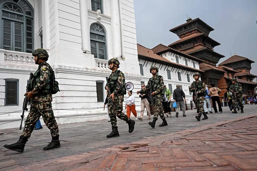Nepal Army personnel patrol a street on the eve of Nepal’s parliamentary elections in Kathmandu on 4 March 2026. (Prakash Mathema/AFP)