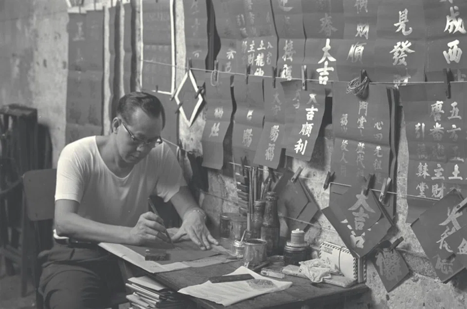 A calligrapher at his stall in Chinatown, Singapore. (SPH Media)