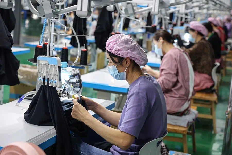 Employees work on a T-shirt production line at a clothing factory in Binzhou, in eastern China’s Shandong province on 22 April 2025. (AFP)