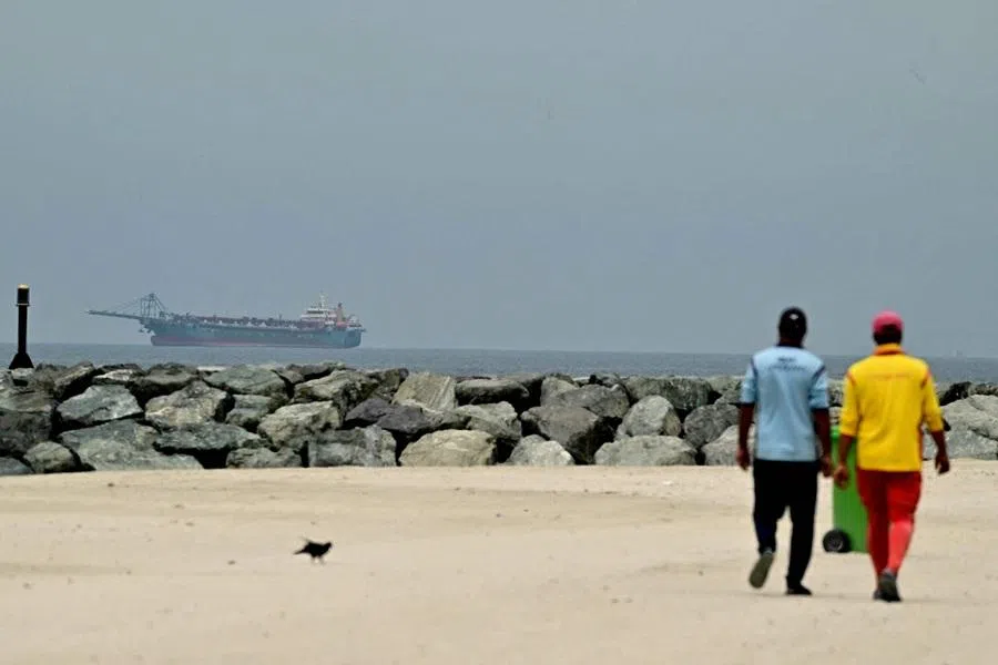 A ship is seen in the Persian Gulf off the coast of Sharjah the day after the failure of US-Iran peace talks on 13 April 2026. (AFP)