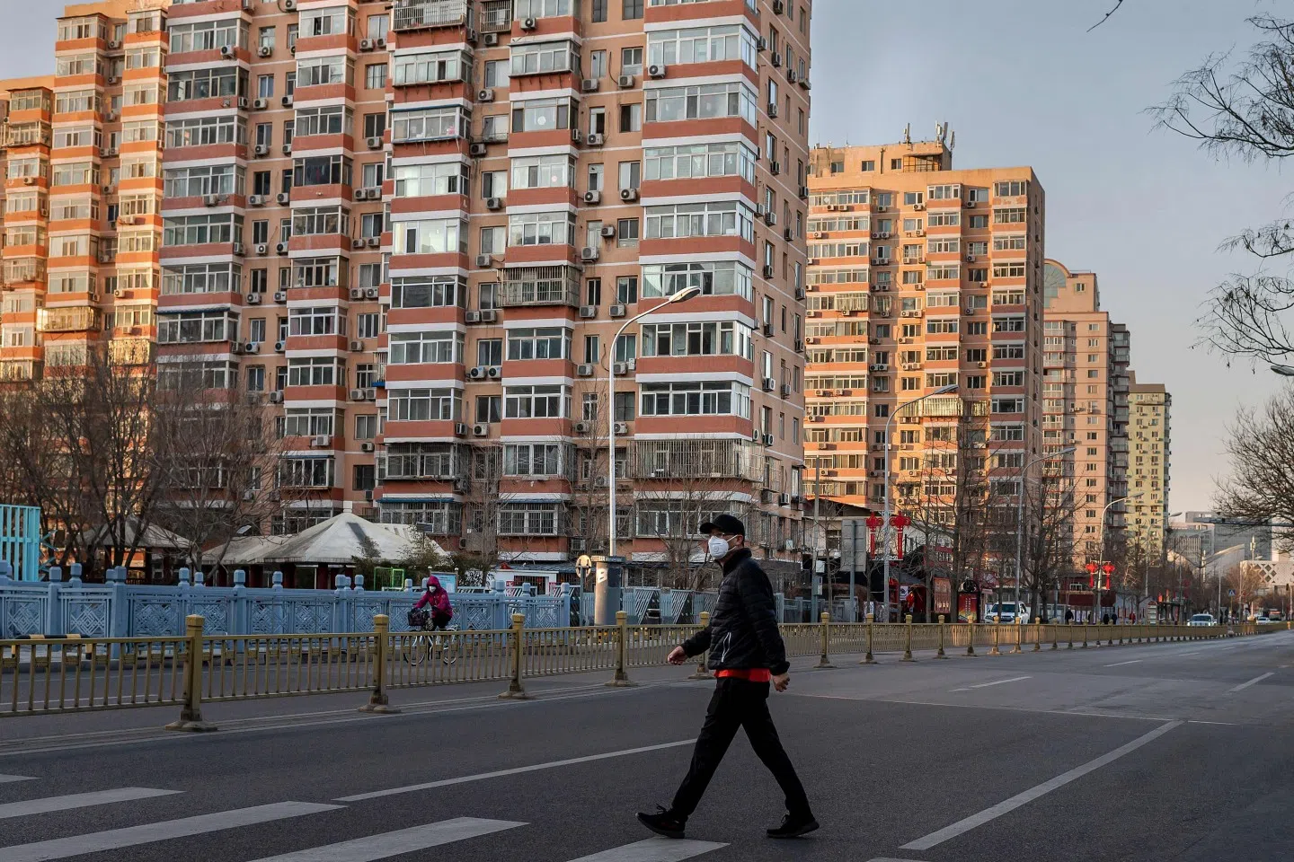 A man wearing a protective mask walks along an empty street in Beijing on 31 January 2020, following the Wuhan coronavirus outbreak. (Nicolas Asfouri/AFP)