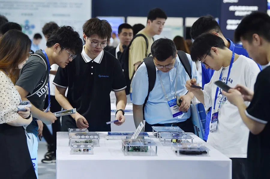 People watch exhibits during the World Semiconductor Congress in Nanjing, Jiangsu province, China, on 19 July 2023. (AFP)