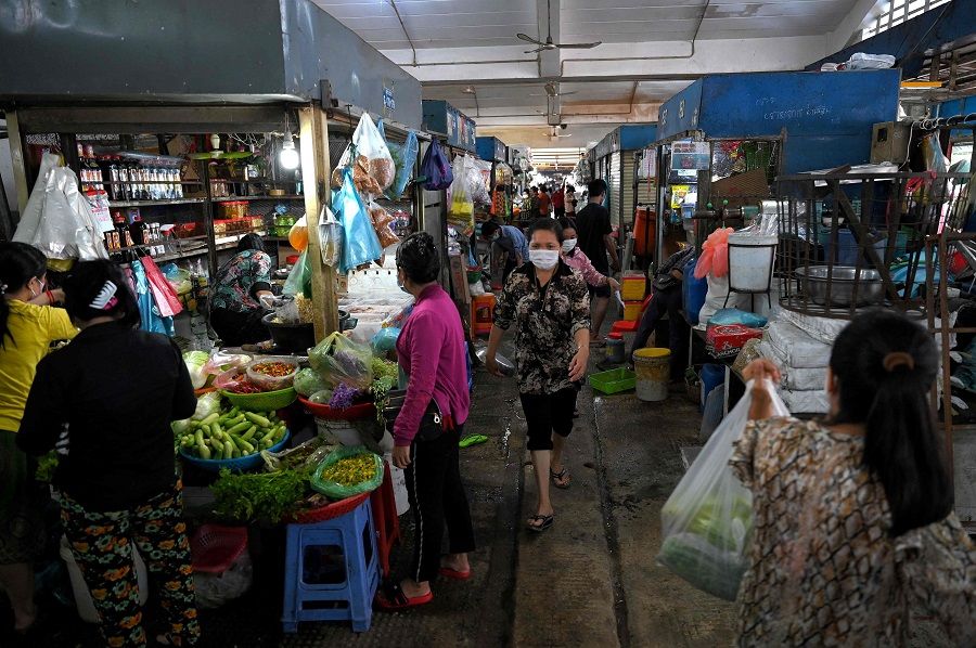 People walk through the Central Market in Phnom Penh, Cambodia on 24 May 2021. (Tang Chhin Sothy/AFP)