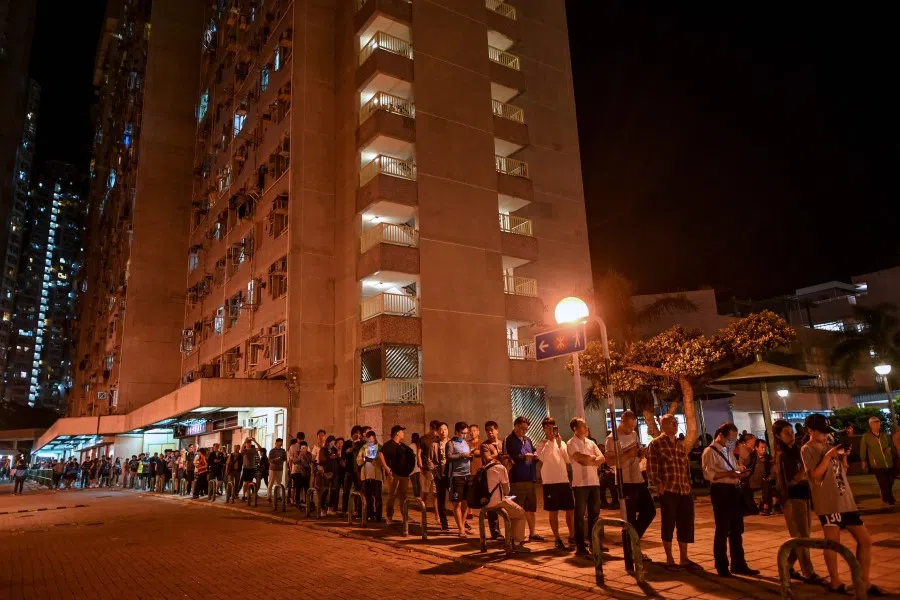 People queue to cast their vote during the district council elections. Hong Kong's voters turned out in record numbers on November 24. (Ye Aung Thu/AFP)