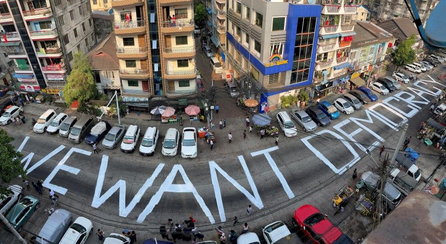 A slogan is written on a street as a protest after the coup in Yangon, Myanmar, 21 February 2021. (Stringer/Reuters)