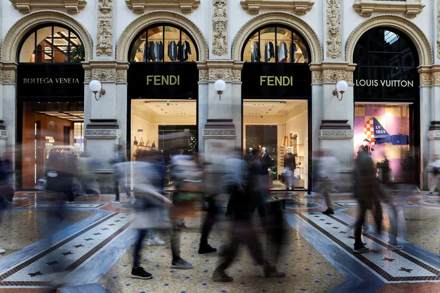 People walk past Bottega Veneta, Fendi and Louis Vuitton stores in Galleria Vittorio Emanuele II, in Milan, Italy, on 27 September 2025. (Yara Nardi/Reuters)
