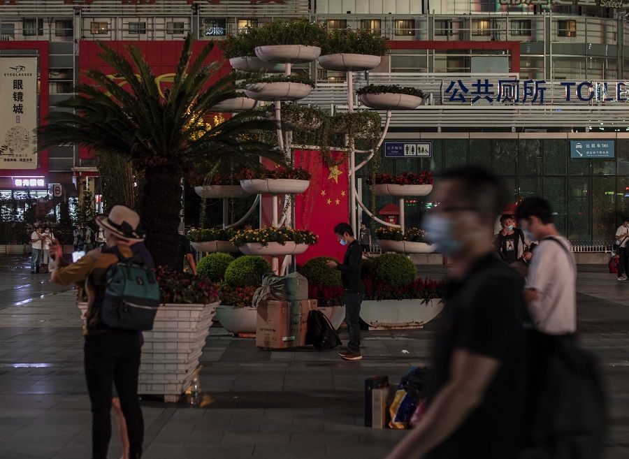Travellers gather in the square outside Shanghai Railway Station in Shanghai, China, on 29 September 2021. (Qilai Shen/Bloomberg)