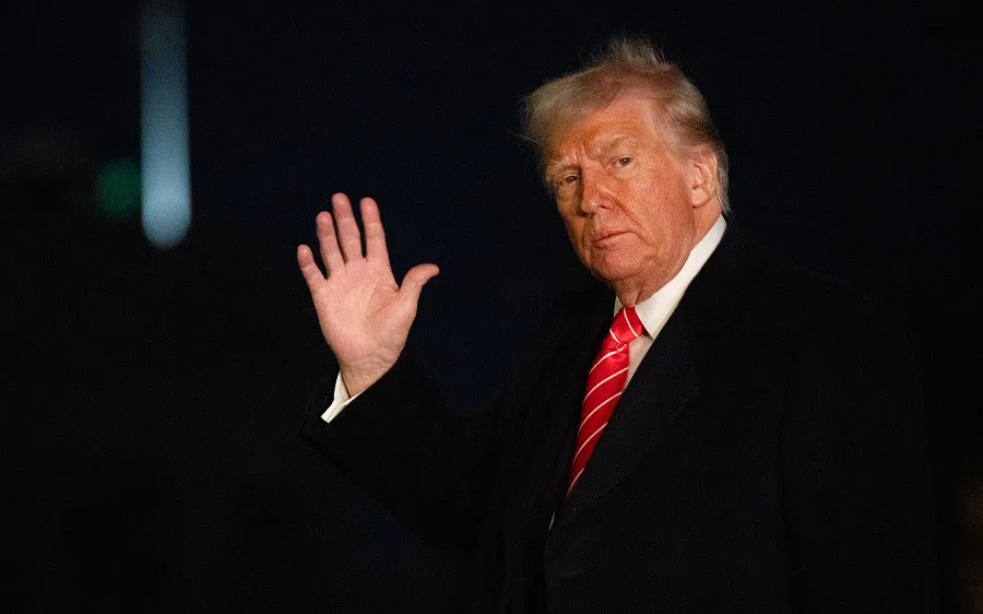 US President Donald Trump waves to press as he arrives at the White House on the South Lawn in Washington, DC, on 23 March 2025. (Anabelle Gordon/AFP)
