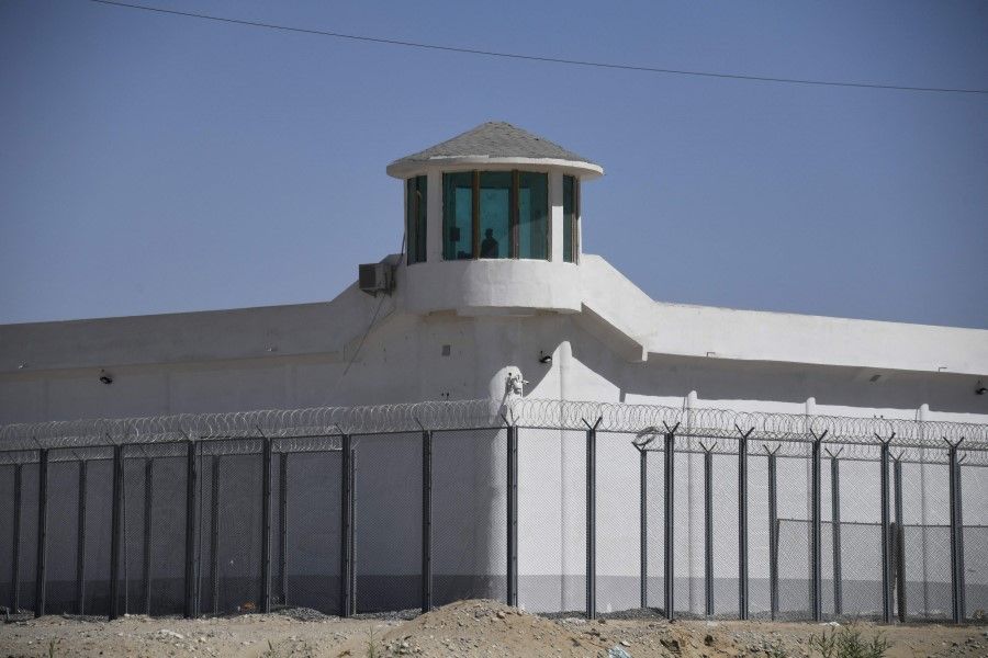 This file photo taken on 31 May 2019 shows a watchtower on a high-security facility near what is believed to be a re-education camp where mostly Muslim ethnic minorities are detained, on the outskirts of Hotan, in China's northwestern Xinjiang region. (Greg Baker/AFP)