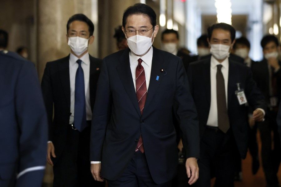 Fumio Kishida, Japan's prime minister, walks inside the lower house of parliament ahead of an extraordinary session in Tokyo, Japan, on 6 December 2021. (Kiyoshi Ota/Bloomberg)