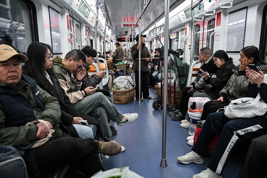 People on the subway train in Chongqing, China on 5 March 2025.  (Hector Retamal/AFP)
