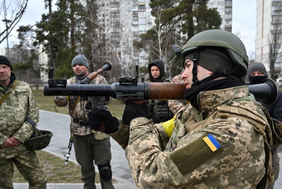 Members of the Ukrainian Territorial Defence Forces examine new armament, including NLAW anti-tank systems and other portable anti-tank grenade launchers, in Kyiv on 9 March 2022, amid the ongoing Russia's invasion of Ukraine. (Genya Savilov/AFP)