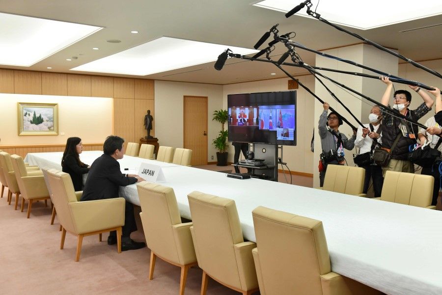Japan's Foreign Minister Toshimitsu Motegi (2nd L) speaks during the Japan-China-South Korea Foreign Ministers' teleconference at the foreign ministry in Tokyo on March 20, 2020. (Kazuhiro Nogi/AFP)