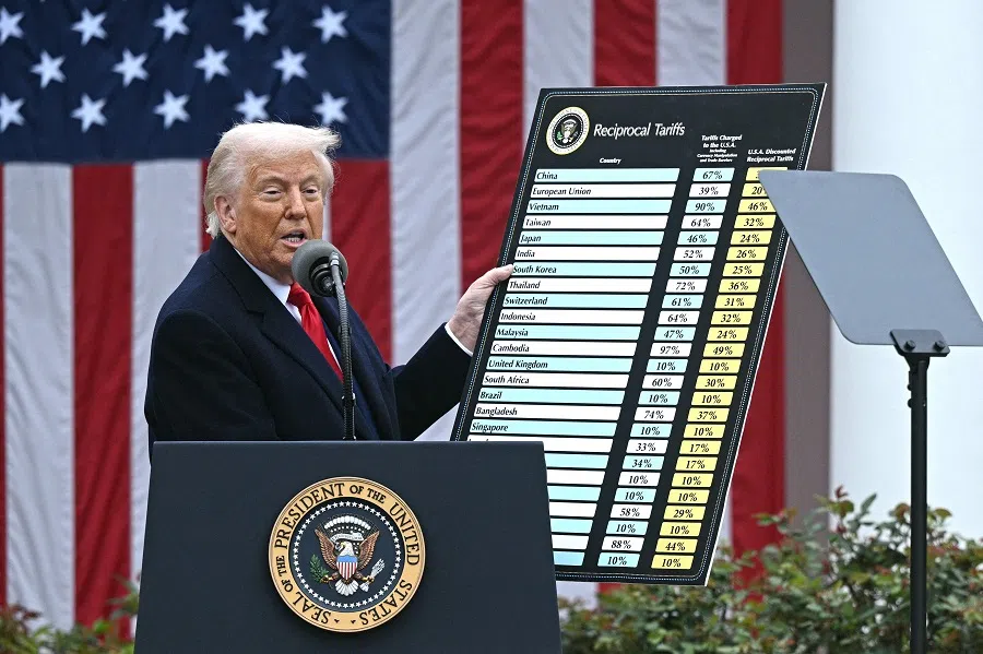 US President Donald Trump holds a chart as he delivers remarks on reciprocal tariffs during an event in the Rose Garden entitled “Make America Wealthy Again” at the White House in Washington, DC, on 2 April 2025. (Brendan Smialowski/AFP)