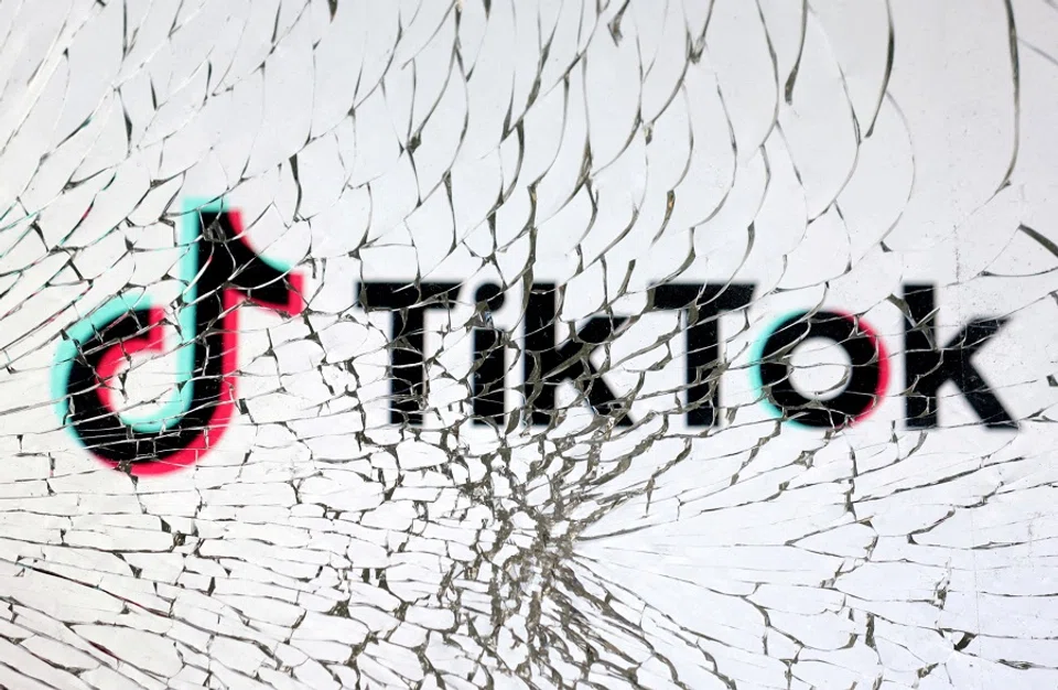 The TikTok logo is seen through broken glass in this illustration taken on 25 January 2023. (Dado Ruvic/Reuters)