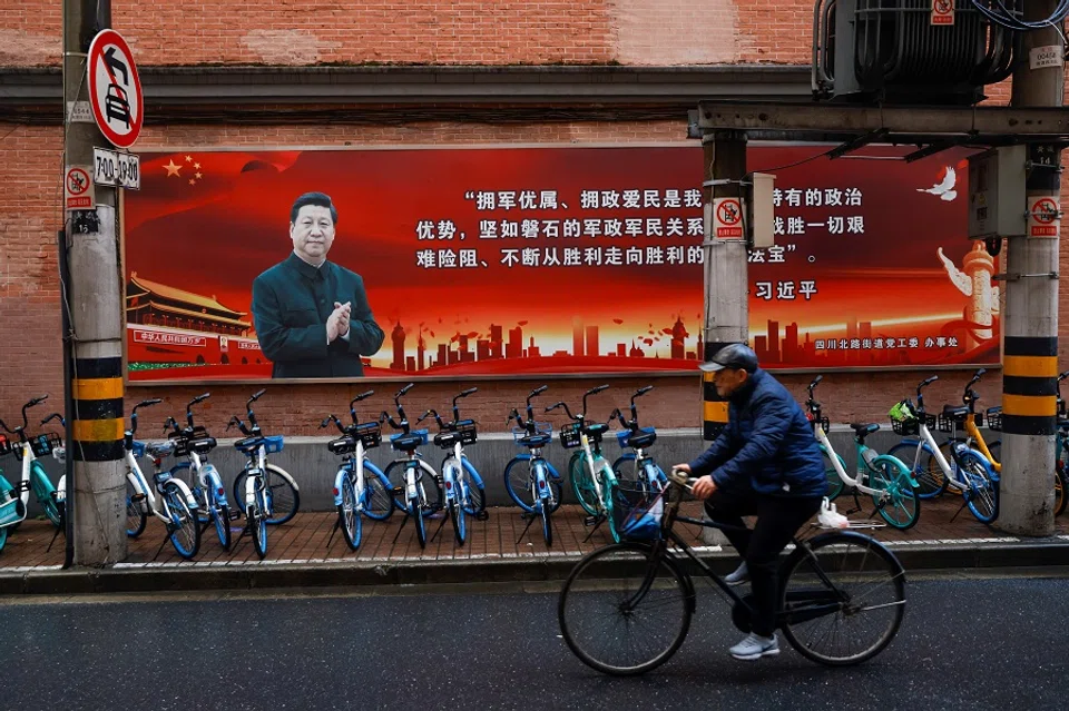 A picture of Chinese President Xi Jinping overlook a street ahead of the National People's Congress (NPC), in Shanghai, China, 1 March 2021. (Aly Song/Reuters)