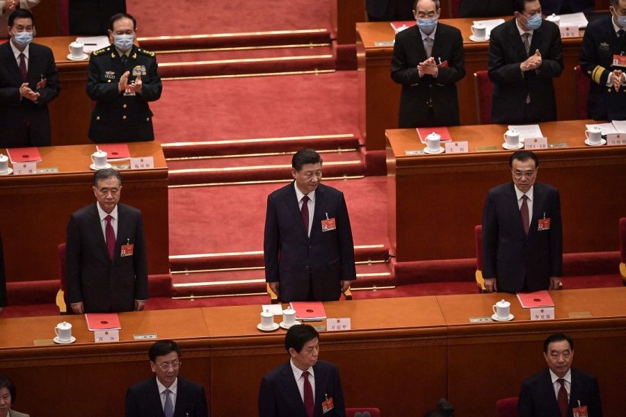 Politburo Standing Committee member Wang Yang (left), President Xi Jinping (centre) and Premier Li Keqiang (right) arrive for the closing session of the National People's Congress (NPC) at the Great Hall of the People in Beijing on 11 March 2021. (Nicolas Asfouri/AFP)