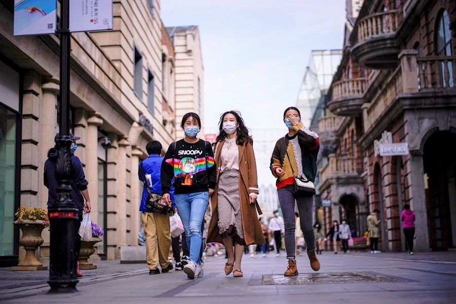 China can easily face a passive disadvantage in handling its external relations if callow nationalists gain control of the Internet. In this photo taken on 14 April 2020, people wearing face masks are seen at a main shopping area after the lockdown was lifted in Wuhan, China. (Aly Song/Reuters)