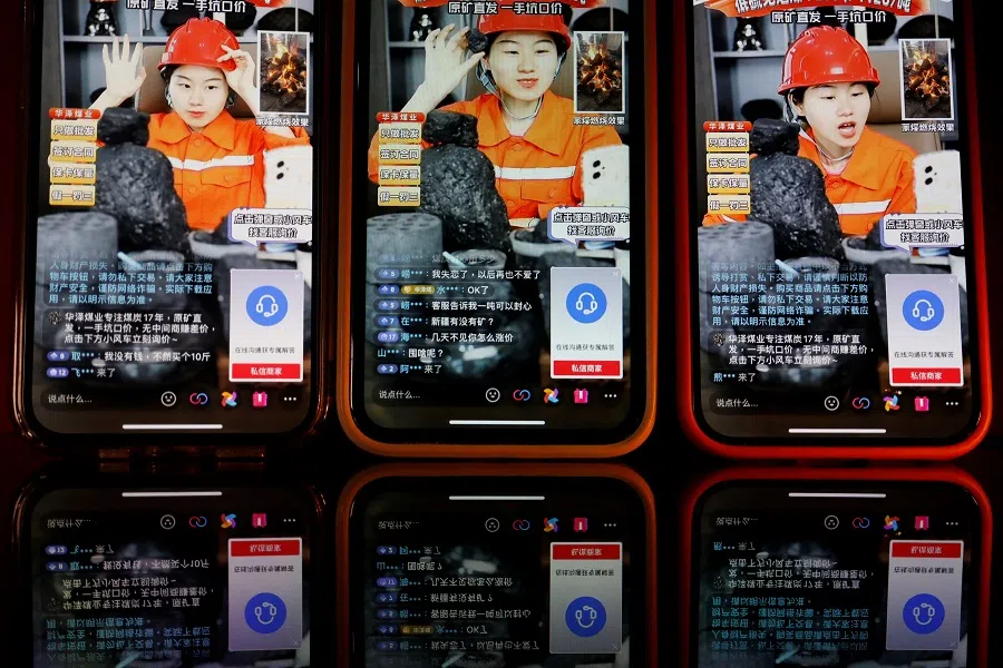 A livestreamer promotes coal during a livestreaming session on the Douyin app, in this illustration picture taken on 15 June 2023. (Florence Lo/Illustration/Reuters)
