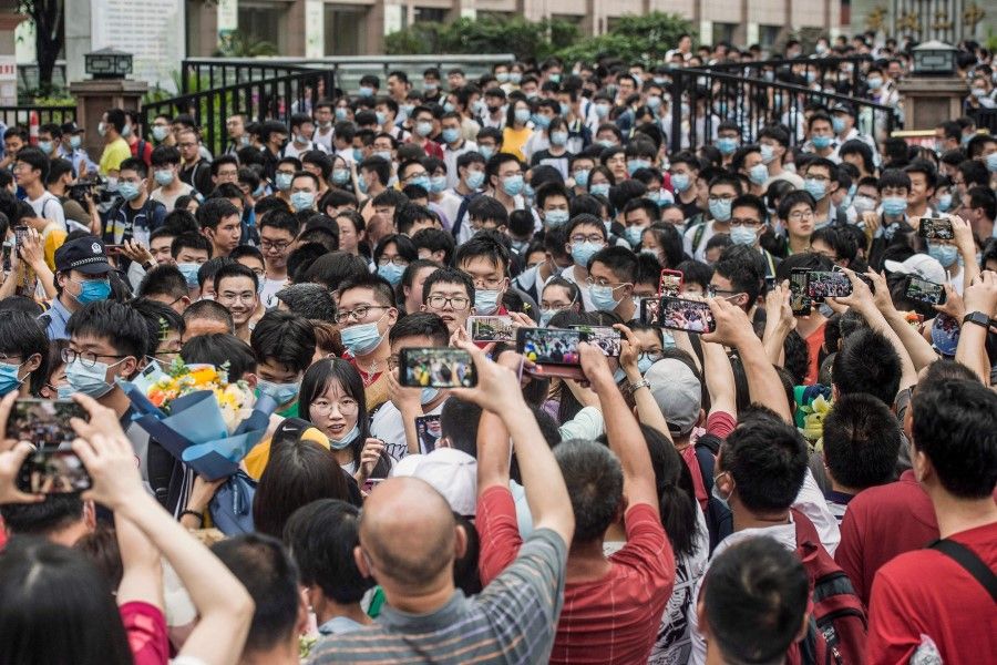 This photo taken on 9 June 2021 shows students leaving a school after finishing the National College Entrance Examination (NCEE), known as Gaokao, in Wuhan, in China's central Hubei province. (STR/AFP)