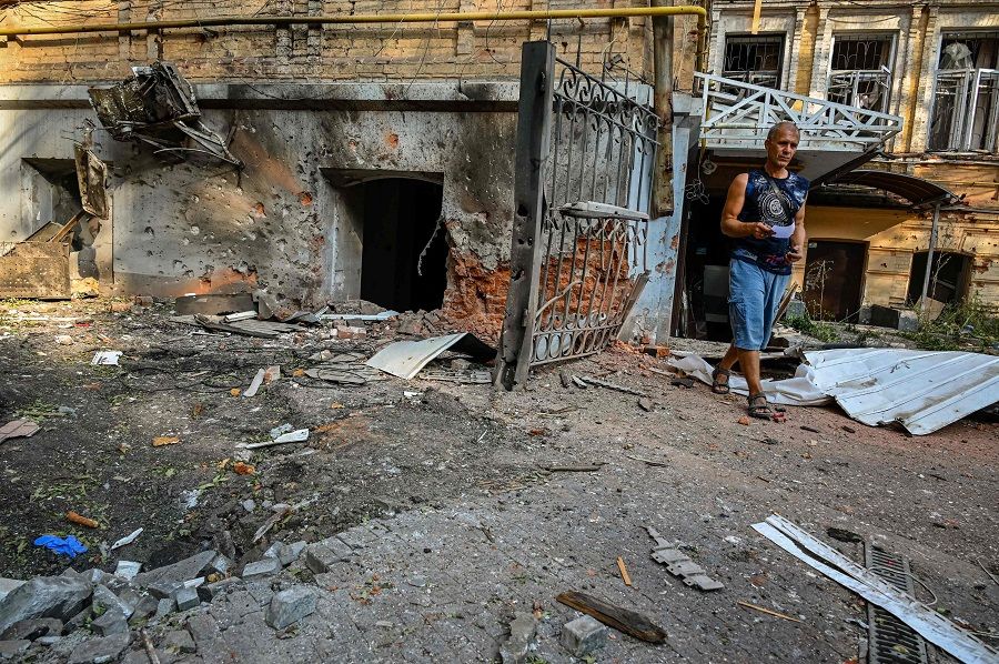 A man walks through the rubble of a damaged building following shelling in Kharkiv, Ukraine, on 30 August 2022, amid the Russian invasion of Ukraine. (Sergey Bobok/AFP)