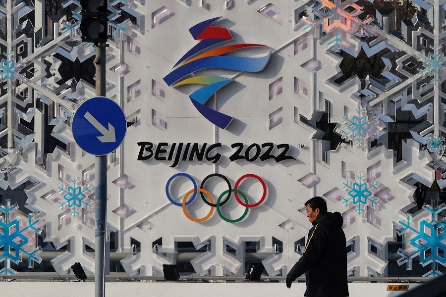 A man walks past an installation of Beijing 2022 ahead of the Beijing 2022 Winter Olympics in Beijing, China, 25 January 2022. (Tyrone Siu/File Photo/Reuters)