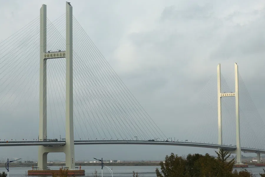 Trucks cross the newly opened New Yalu River Bridge, which connects China’s Dandong New Zone and North Korea’s Sinuiju, as seen from Dandong, Liaoning province, China, on 15 October 2026.