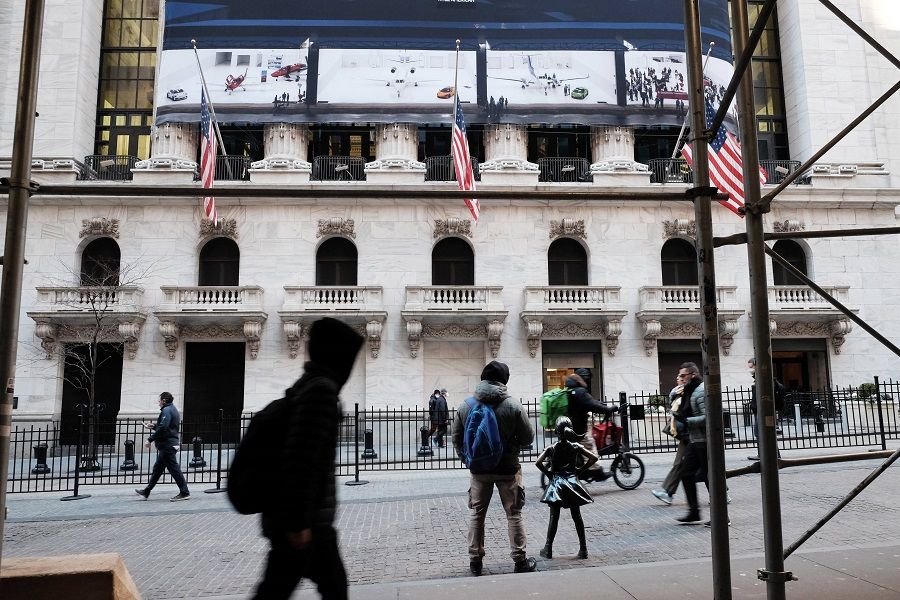 People walk by the New York Stock Exchange (NYSE) in the Financial District on 26 January 2022 in New York City, US. (Spencer Platt/Getty Images/AFP)
