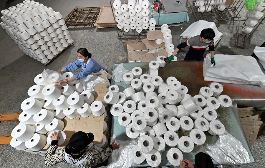 Workers are seen on the production line at a cotton textile factory in Korla, Xinjiang, China, 1 April 2021. (CNS photo via Reuters)