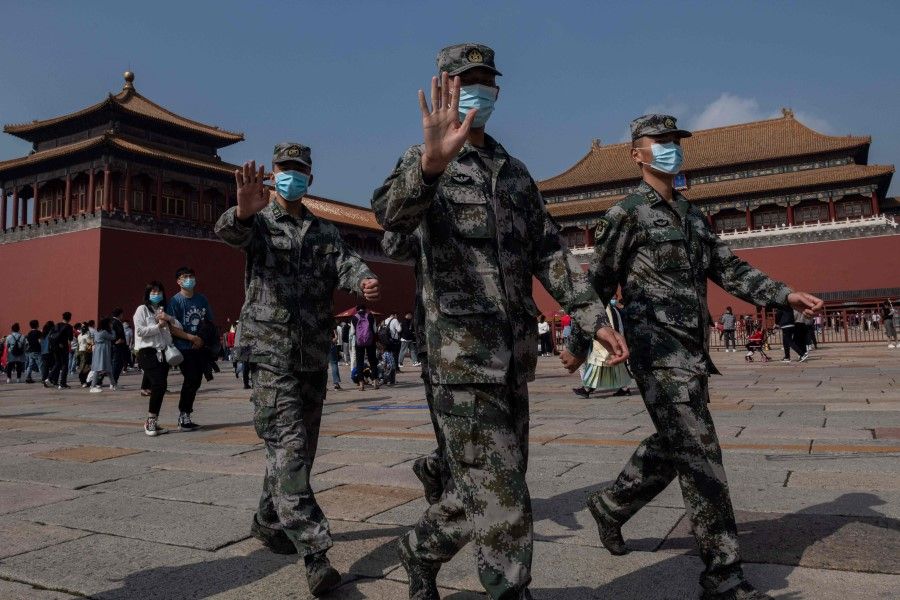 Chinese soldiers walk outside the Forbidden City (back) during the national day marking the 71st anniversary of the People's Republic of China and the country's national "Golden Week" holiday in Beijing on 1 October 2020. (Nicolas Asfouri/AFP)