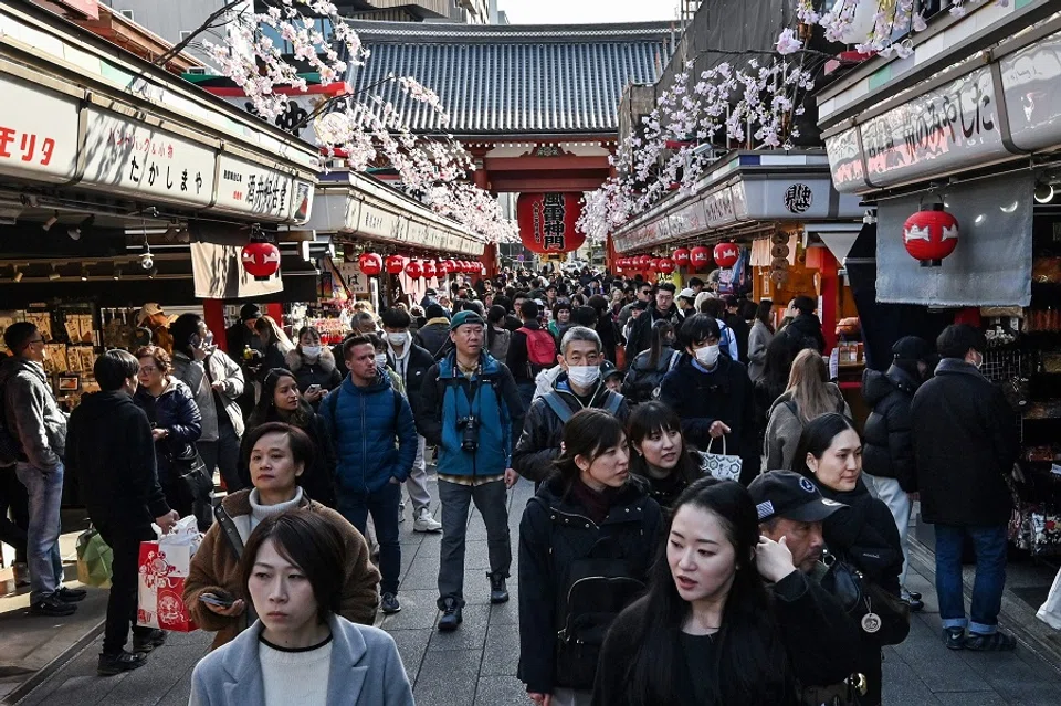 People walk along the main shopping street at Sensoji Temple in the popular tourist destination of Asakusa in central Tokyo on 21 February 2025. (Richard A. Brooks/AFP)