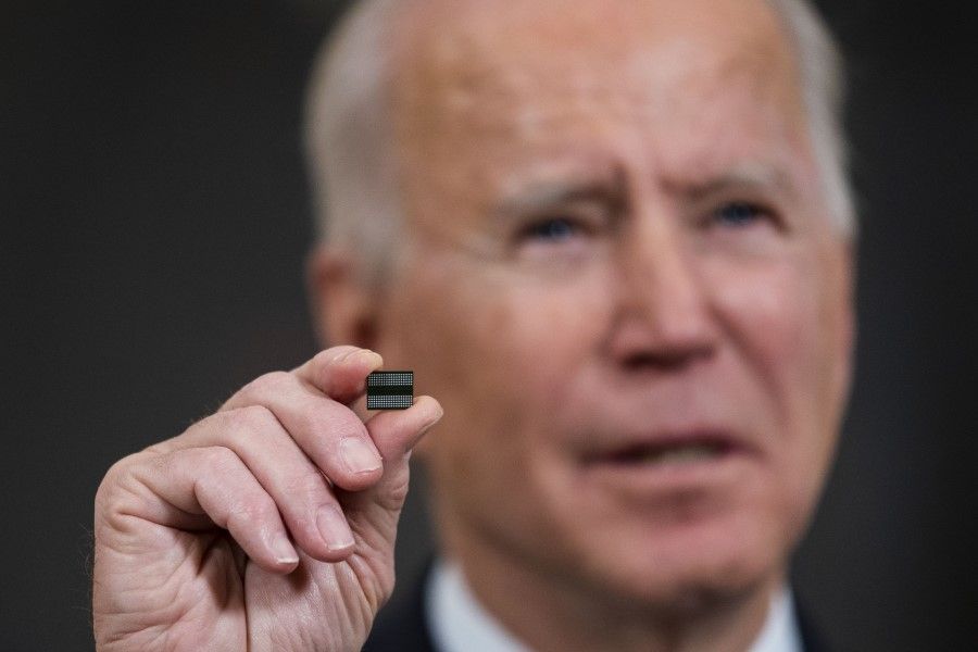 U.S. President Joe Biden holds a semiconductor before signing an executive order in the State Dining Room of the White House in Washington, DC, US on 24 February 2021. Biden ordered a government review of US supply chains, seeking to end the country's reliance on China and other adversaries for crucial goods. (Doug Mills/Bloomberg)