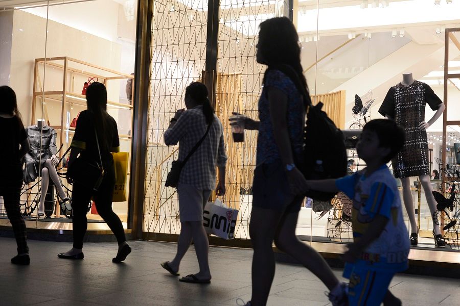 Shoppers walk past a boutique store at Mandarin Gallery along Orchard Road in Singapore. (SPH Media)