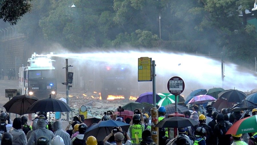 Police using water cannon to spray at protesters at Hong Kong Polytechnic University. (SPH)