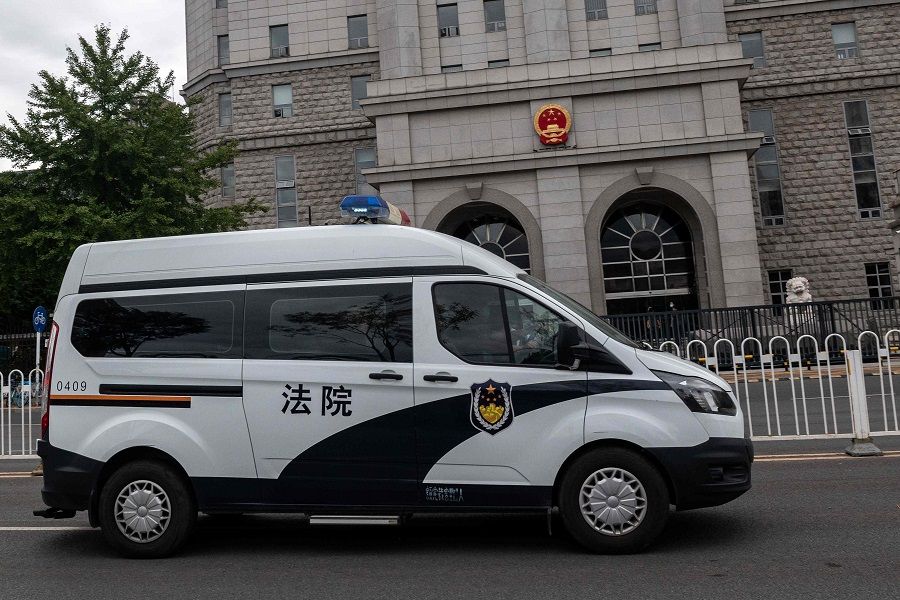 An escorted police van carrying Chinese property tycoon Ren Zhiqiang leaves the Beijing No. 2 Intermediate People's Court on 11 September 2020, after Ren's case was heard. Ren was detained after penning an essay fiercely critical of President Xi Jinping's response to the coronavirus outbreak. (Nicolas Asfouri/AFP)