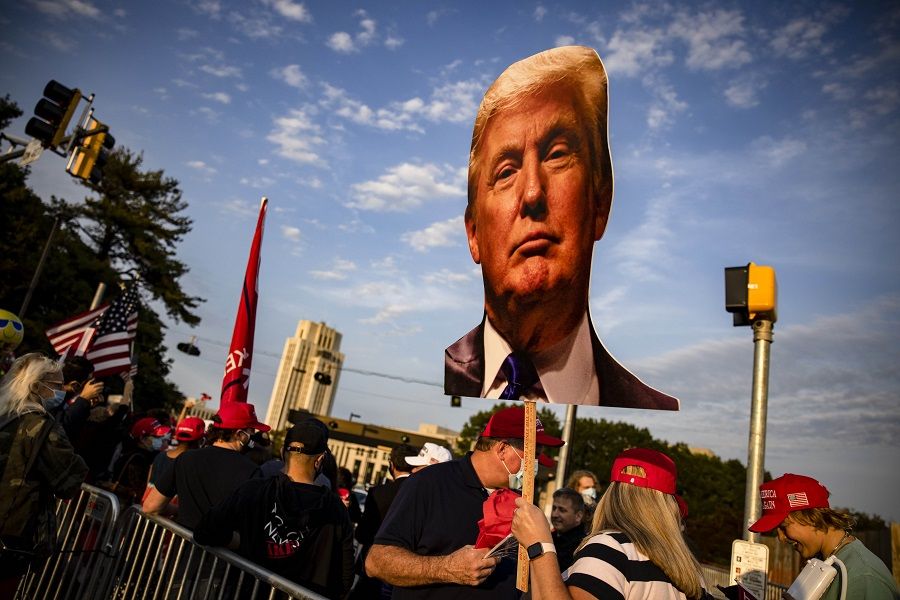 Supporters of US President Donald Trump gather outside of Walter Reed National Military Medical Center after the President was admitted for treatment of Covid-19 on 4 October 2020 in Bethesda, Maryland. (Samuel Corum/Getty Images/AFP)