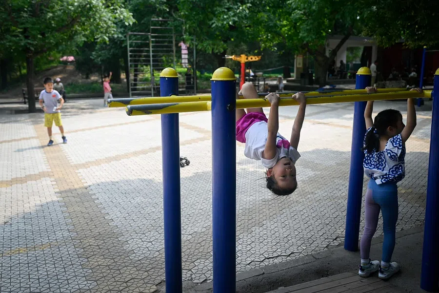 A group of children play at a park in Beijing, China, on 4 July 2024. (Wang Zhao/AFP)
