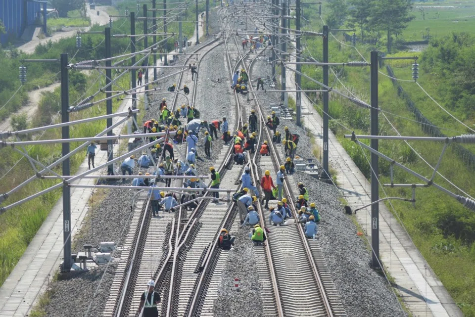 Workers check an electronic system at the Tegalluar station of the China-made high speed railway connecting the capital city of Jakarta with Bandung, in Bandung, West Java on 15 May 2023. (Timur Matahari/AFP)