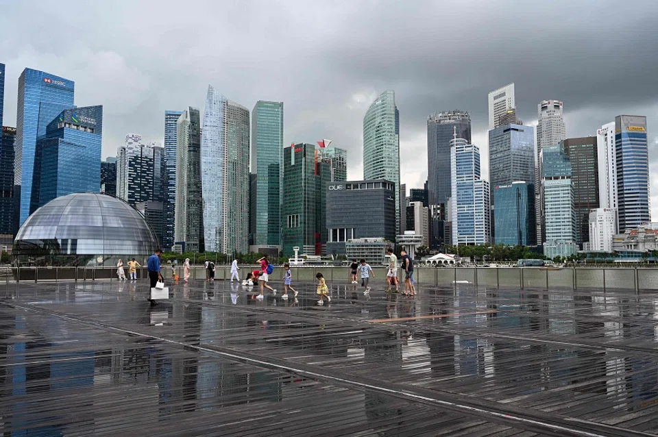 People gather on the boardwalk at Marina Bay in Singapore on 9 January 2024. (Roslan Rahman/AFP)